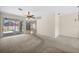 Bright living room with a ceiling fan and glass sliding doors that provide natural light and backyard access at 4538 Appleton Ter, North Port, FL 34286