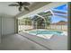 Outdoor living space showcasing a screened pool area with concrete flooring and a ceiling fan in the covered area at 4538 Appleton Ter, North Port, FL 34286