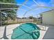 Backyard swimming pool within screened lanai, surrounded by concrete deck and grassy yard beyond the fence at 4538 Appleton Ter, North Port, FL 34286