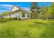 Lush backyard with healthy green grass, attractive landscaping, privacy fence, and screened in patio at 4581 Majestic Hills Loop, Brooksville, FL 34601