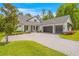 Beautiful two-story home featuring a three car garage, manicured landscaping, and a light colored driveway at 4581 Majestic Hills Loop, Brooksville, FL 34601