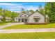 Charming home with a manicured lawn, dark trim, decorative awning, and attractive landscaping at 4581 Majestic Hills Loop, Brooksville, FL 34601