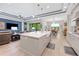 Open-concept kitchen and living room area featuring modern lighting and stainless steel appliances at 4581 Majestic Hills Loop, Brooksville, FL 34601