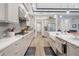 Modern kitchen with white countertops, gray cabinets, and stainless steel appliances at 4581 Majestic Hills Loop, Brooksville, FL 34601