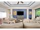 Living room featuring tray ceilings, hardwood floors, and views to the outdoor areas at 4581 Majestic Hills Loop, Brooksville, FL 34601