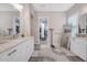 Bright bathroom boasts double sinks, a walk-in closet, and a large mirror at 4581 Majestic Hills Loop, Brooksville, FL 34601