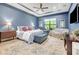 Spacious bedroom boasts stylish decor, tray ceilings, and a cozy sitting area at 4581 Majestic Hills Loop, Brooksville, FL 34601