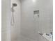 The walk-in shower features sleek tile and a convenient built-in niche at 4581 Majestic Hills Loop, Brooksville, FL 34601