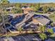 Stunning aerial view of a private home with a screened in porch, verdant landscaping, and mature trees at 5010 Umber N Way, Tampa, FL 33624