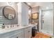 Spa-like bathroom featuring a double vanity, marble countertops, and a glass-enclosed shower at 5010 Umber N Way, Tampa, FL 33624