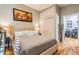 Cozy bedroom with a queen bed, artwork, and view to adjacent office at 5010 Umber N Way, Tampa, FL 33624