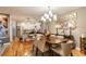 Elegant dining room with a chandelier, seating for six, and hardwood floors at 5010 Umber N Way, Tampa, FL 33624