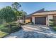 Charming home with lush landscaping and a private garage on a sunny day at 5010 Umber N Way, Tampa, FL 33624