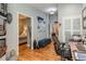 Hallway with views to the adjacent bedroom and office featuring hardwood floors at 5010 Umber N Way, Tampa, FL 33624