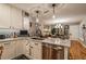 Open kitchen featuring marble countertops, stainless steel dishwasher, and view into dining area at 5010 Umber N Way, Tampa, FL 33624