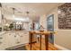 Bright kitchen featuring an island with barstool seating and modern pendant lighting at 5010 Umber N Way, Tampa, FL 33624