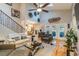 Bright living room with tall ceilings, hardwood floors, staircase, and access to the outdoor lanai at 5010 Umber N Way, Tampa, FL 33624
