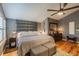 Comfortable main bedroom features a padded headboard, a ceiling fan, and beautiful decor at 5010 Umber N Way, Tampa, FL 33624