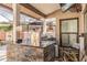Stylish outdoor kitchen features stone accents, granite counters, a built-in grill, and a beer dispenser at 5010 Umber N Way, Tampa, FL 33624