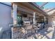 Outdoor bar area with granite counters, stone accents, a ceiling fan, and outdoor seating, ideal for entertaining at 5010 Umber N Way, Tampa, FL 33624