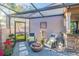 Cozy outdoor patio with gravel floor, comfortable chairs, fire pit, and privacy wall, perfect for relaxation at 5010 Umber N Way, Tampa, FL 33624