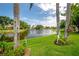 Scenic view of a serene lake framed by mature trees and manicured green spaces at 5519 Greyston St, Palm Harbor, FL 34685