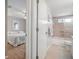 Bathroom with shower-tub combination, pink tile, and access to the Primary bedroom at 5519 Greyston St, Palm Harbor, FL 34685