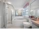Bathroom featuring walk-in shower, bathtub, toilet, and vanity area with drawers and mirror at 5519 Greyston St, Palm Harbor, FL 34685