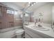 Bathroom with shower-tub combination, single sink vanity, and pink tile at 5519 Greyston St, Palm Harbor, FL 34685