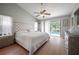 Bedroom featuring a ceiling fan, hardwood floors, and view of the pool at 5519 Greyston St, Palm Harbor, FL 34685