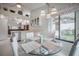 Bright dining area featuring a round glass table, with a view of the kitchen and outdoor space at 5519 Greyston St, Palm Harbor, FL 34685