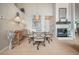 Elegant dining room with a modern light fixture, fireplace, and a blend of textures and decor at 5519 Greyston St, Palm Harbor, FL 34685