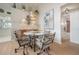 Stylish dining area with decor, modern light fixture and a view of the living area and bathroom at 5519 Greyston St, Palm Harbor, FL 34685