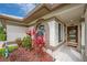 Inviting front entry with decorative plants and a glass accented door at 5519 Greyston St, Palm Harbor, FL 34685