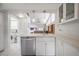 Modern kitchen featuring stainless steel appliances, light countertops and a view of the living area at 5519 Greyston St, Palm Harbor, FL 34685