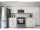 Well-equipped kitchen featuring white cabinets, stainless steel appliances, and stylish backsplash at 5519 Greyston St, Palm Harbor, FL 34685