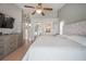 A spacious primary bedroom featuring wood floors, a ceiling fan, and a picturesque view of the backyard at 5519 Greyston St, Palm Harbor, FL 34685