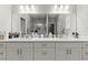 Bright bathroom featuring a double sink vanity, large mirror, and modern fixtures at 6406 Sanctuary Creek Ln, Tampa, FL 33625