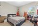 Comfortable bedroom featuring a queen-size bed and natural light from the window at 6406 Sanctuary Creek Ln, Tampa, FL 33625