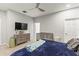 Spacious bedroom with gray dresser, a crib, and relaxing blue bedding at 6406 Sanctuary Creek Ln, Tampa, FL 33625