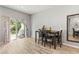 Dining room area with glass sliding door, wood table, and view of the backyard at 6406 Sanctuary Creek Ln, Tampa, FL 33625