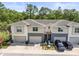 Modern townhome featuring attached garages, neutral color scheme, and manicured landscaping at 6406 Sanctuary Creek Ln, Tampa, FL 33625