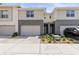 Two-story townhome featuring a one-car garage and neutral-toned siding with gray accents at 6406 Sanctuary Creek Ln, Tampa, FL 33625