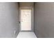 Six-panel front door of the home with secure smart lock and matching wall paint at 6406 Sanctuary Creek Ln, Tampa, FL 33625