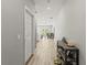 Hallway leads to kitchen/living area with laminate floors and decorated shoe rack at 6406 Sanctuary Creek Ln, Tampa, FL 33625