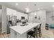 Island kitchen with stainless steel appliances, breakfast bar, and pendant lighting at 6406 Sanctuary Creek Ln, Tampa, FL 33625