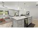 Modern kitchen features an island with white countertop, a sink and stainless steel dishwasher at 6406 Sanctuary Creek Ln, Tampa, FL 33625