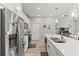 Bright kitchen with stainless steel fridge, large center island, and adjacent living area at 6406 Sanctuary Creek Ln, Tampa, FL 33625