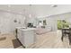 Open floor plan with bright living room connected to island kitchen and dining space at 6406 Sanctuary Creek Ln, Tampa, FL 33625