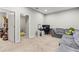 Spacious living room with neutral carpet and a comfortable gray sectional sofa at 6406 Sanctuary Creek Ln, Tampa, FL 33625